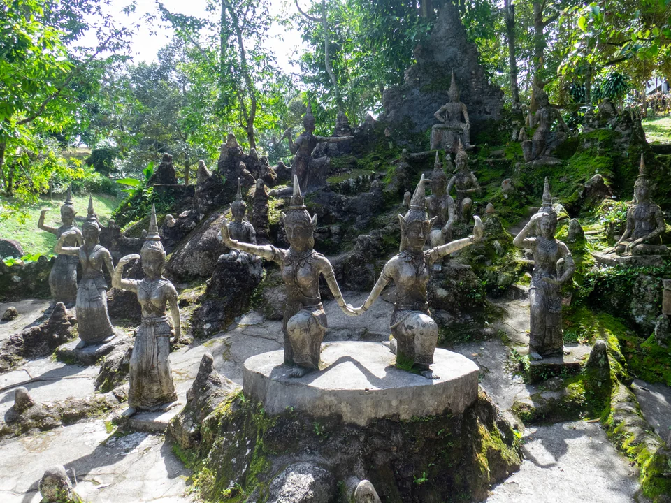Stone statues among the trees at Secret Buddha Garden